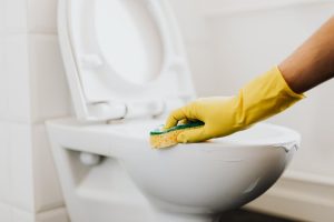 A person cleaning a toilet bowl