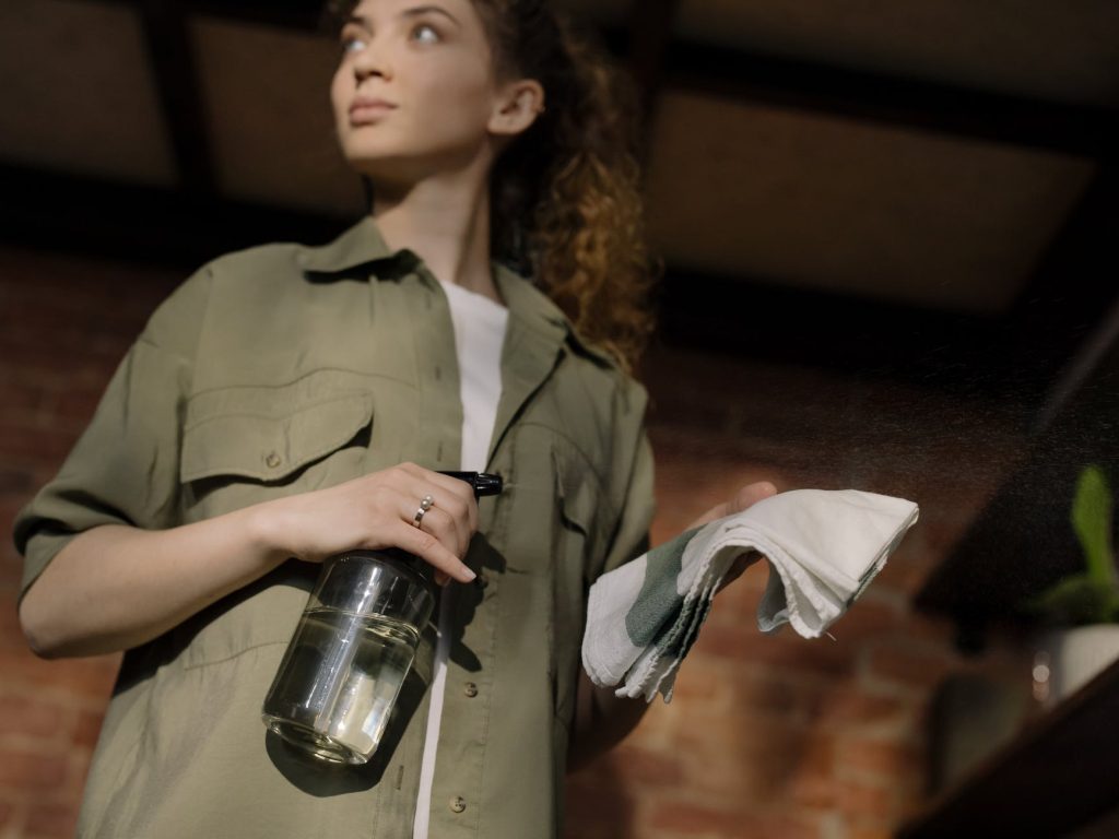 A woman cleaning, representing how cleaners can make your interstate move easier.